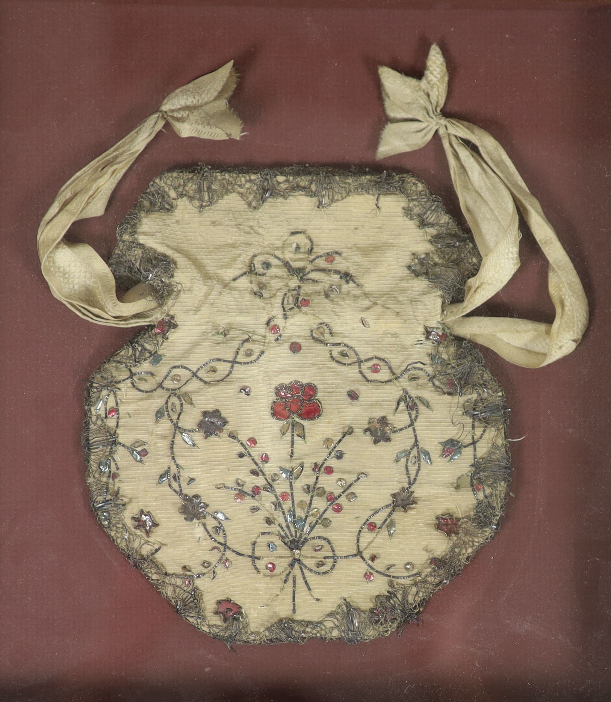 A late 18th century embroidered silk waistcoat, a similar Bible bag and coaching lace purse All framed and glazed, largest frame 51 x 58 cm